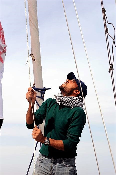 Yachtsman, yachting instructor adjusts the sails on a yacht